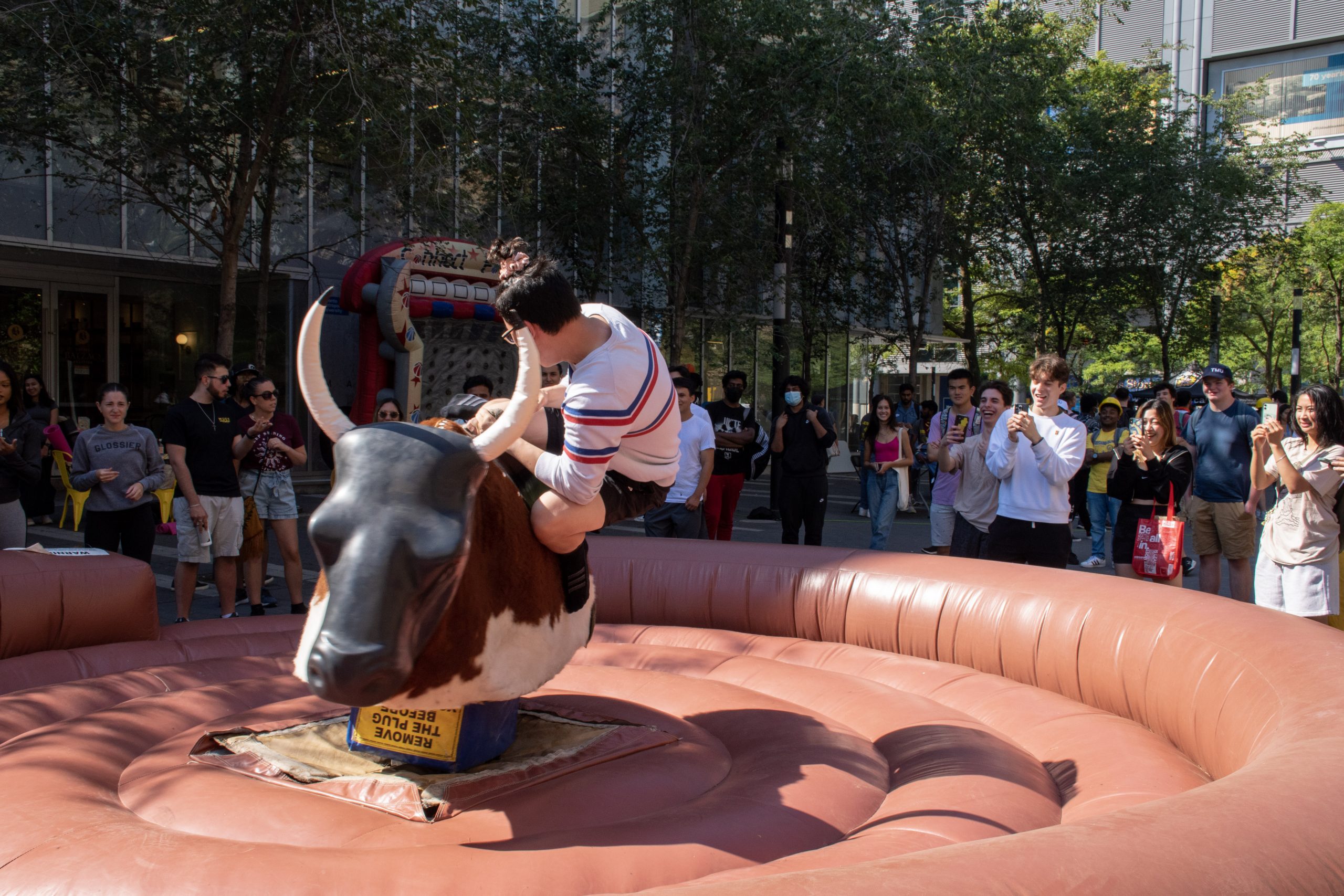 boy riding mechanical bull and falling off