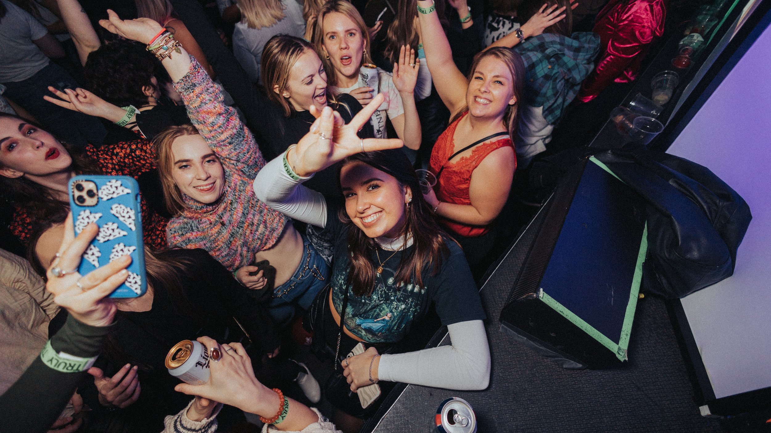 girls posing for the camera at a night event